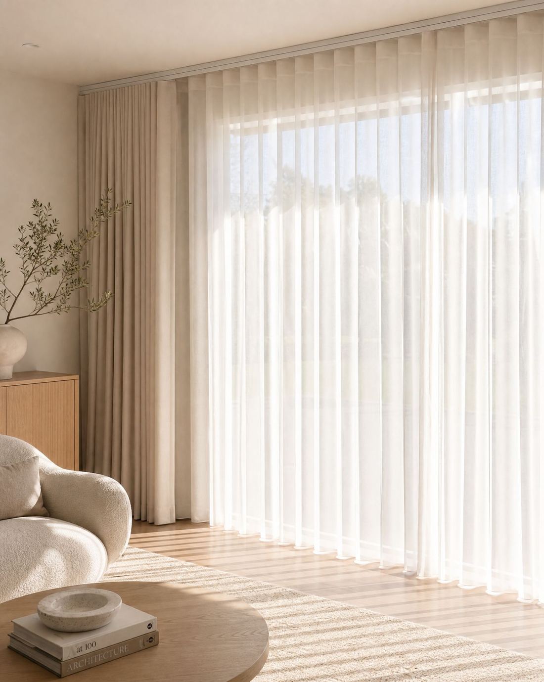 Sheer wave fold curtains filling a living room with soft daylight